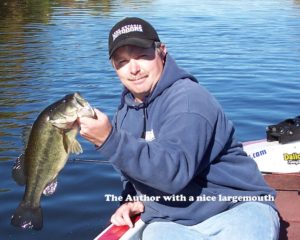Fisherman poses with largemouth while early season bass fishing