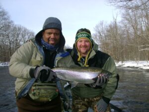 two anglers with a big fish, caught while winter steelhead fishing NY
